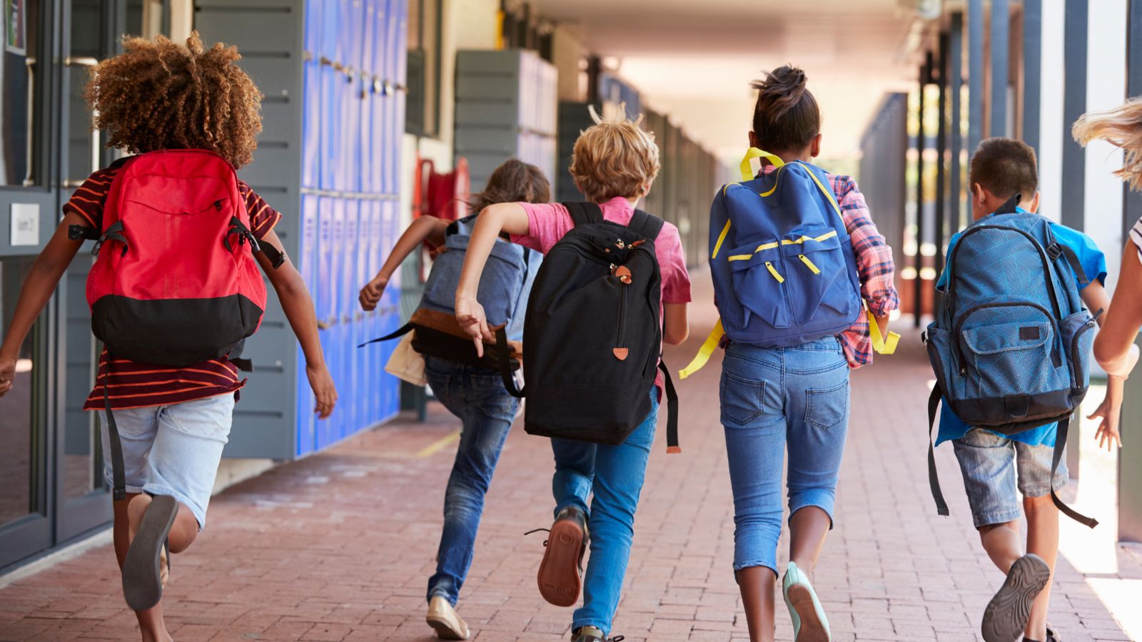 Grupo de niños y niñas corriendo hacia el recreo
